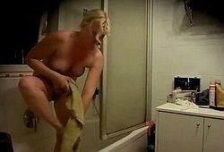 Голая блондинка в ванной комнате