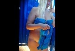 Полненькая блондинка раздевается перед камерой в пляжной кабинке
